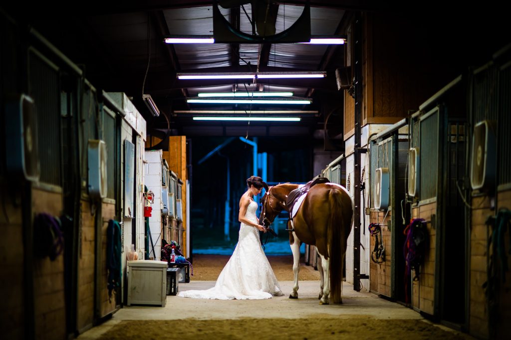 Bride and her horse in the barn