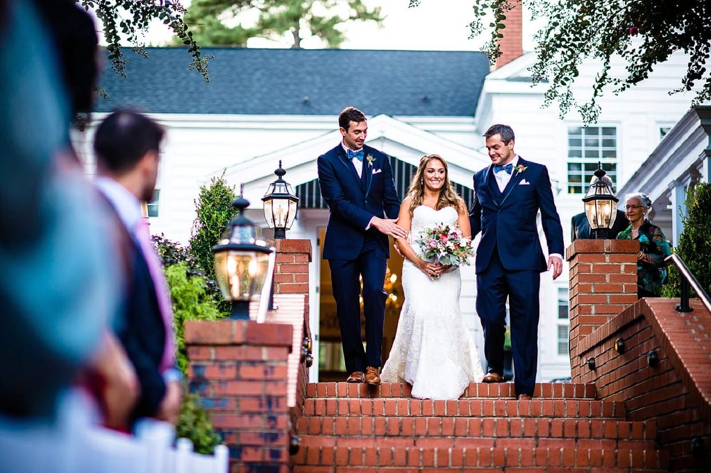 brothers escorting bride down the aisle