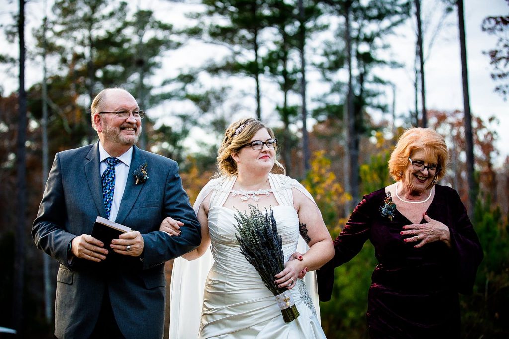 bride coming down aisle with parents