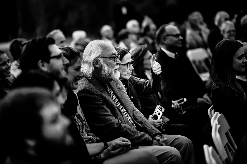 funny guest gesturing to groom