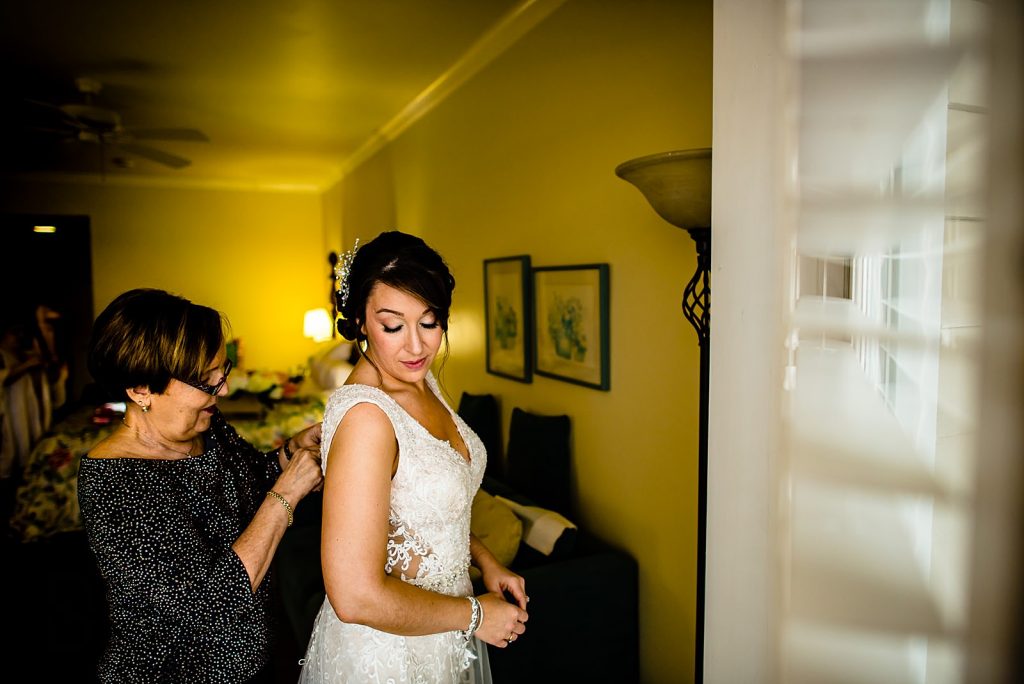 bride and mom getting in dress