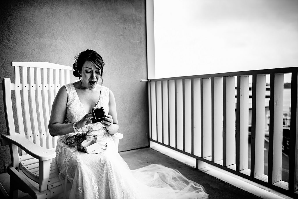bride opening gift from groom