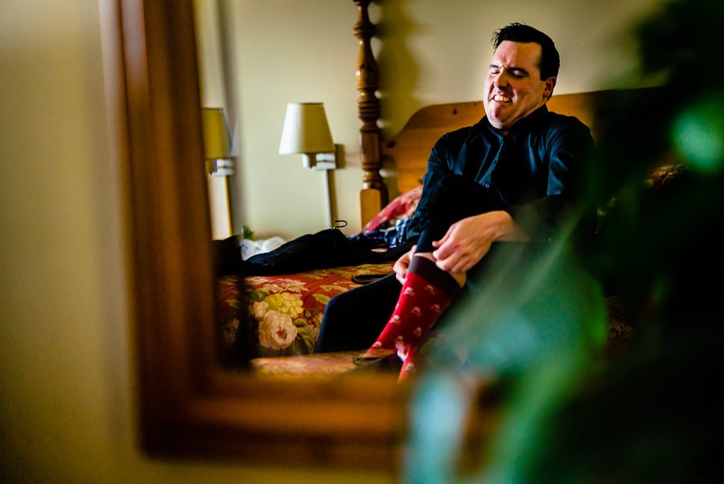 groom aggressively putting socks